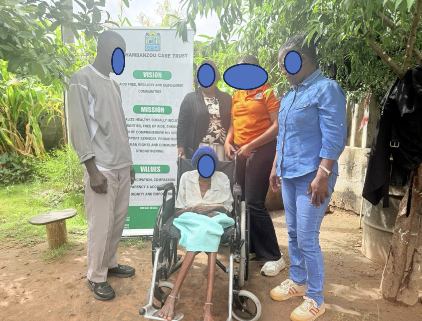 Community members supporting a person in a wheelchair at a Mashambanzou Care Trust outreach