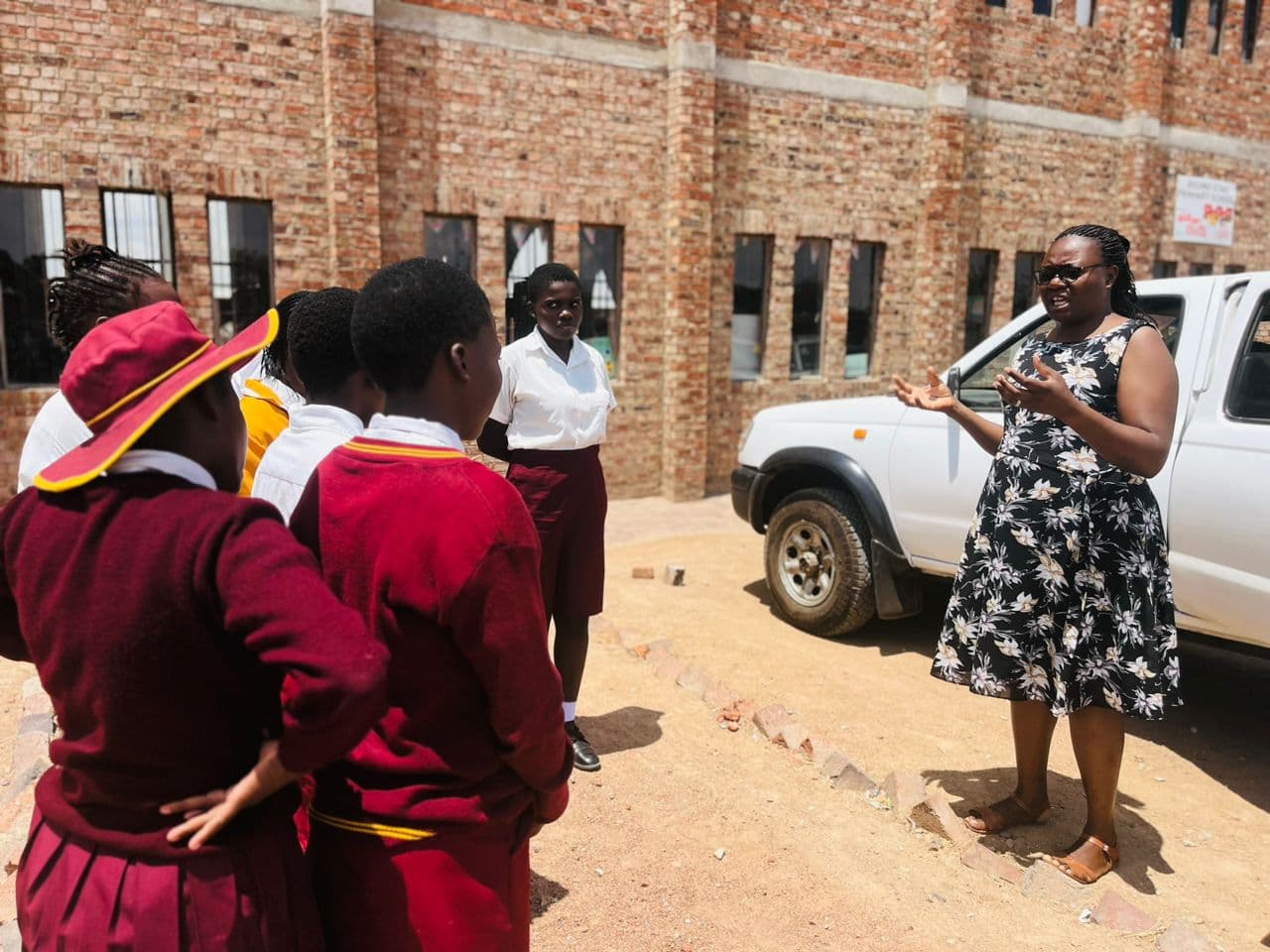 Community educator teaching schoolgirls during a Family Centred Support outreach